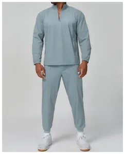 Full view of men's light blue-grey outdoor sports suit with quarter-zip and elastic cuffs