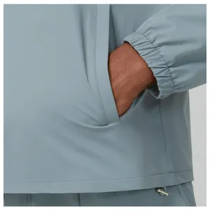 Close-up of side pocket and elastic cuff on men's blue outdoor jacket