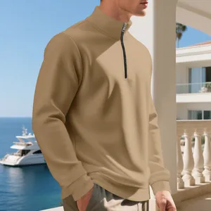 Detail view of men's camel half-zip fleece-lined sweatshirt in a casual outdoor setting