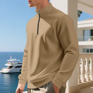 Close-up of men's camel half-zip fleece sweatshirt in a luxury seaside setting