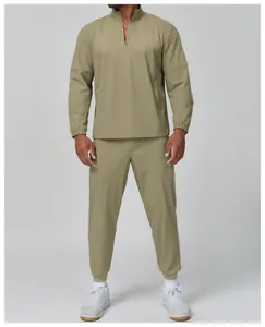 Detailed view of men's khaki sports set featuring quarter-zip jacket and joggers
