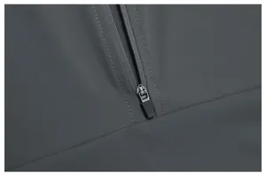 Macro view of the durable zipper and fine fabric texture on a grey outdoor hiking jacket.