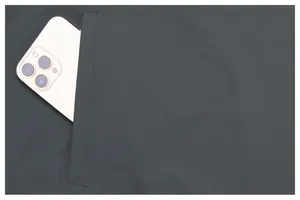 Close-up of men's lightweight hiking jacket pocket with smartphone showing storage capacity