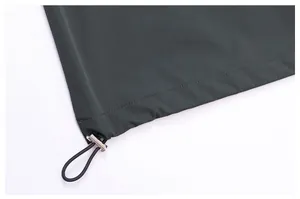 Detail of adjustable drawstring hem with cord lock on men's lightweight outdoor jacket