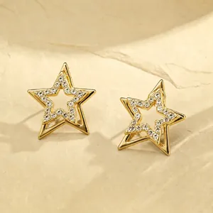 Detailed view of gold-tone double-layer star stud earrings with clear rhinestones