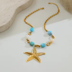 Macro view of golden starfish pendant necklace featuring vintage blue and white beads.