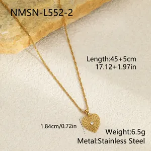 Detail shot of textured gold heart pendant necklace with rhinestone in stainless steel.