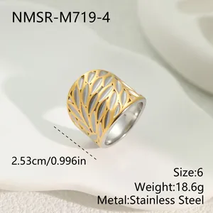 Detail view of two-tone stainless steel wide ring with hollow leaf pattern and measurements