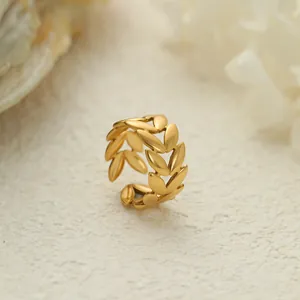 Vista detallada de un anillo abierto vintage de acero dorado con diseño de hoja