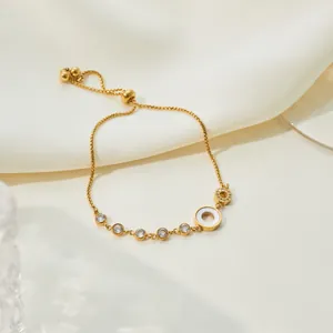 Detailed view of gold-plated stainless steel bracelet with mother-of-pearl inlay