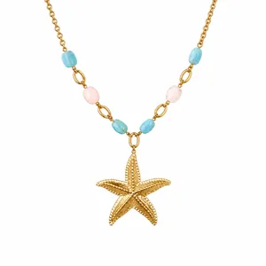 Close-up detail of vintage ocean style necklace featuring a gold starfish pendant and pastel beads
