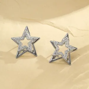 Close-up detail of silver double-layered star earrings with sparkling rhinestones