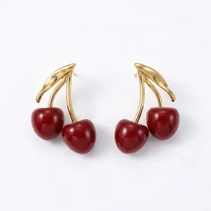 Detailed view of elegant vintage red enamel cherry drop earrings with gold finish leaves