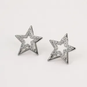 Close-up of elegant silver double-layer star earrings with sparkling inlaid rhinestones