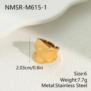 Detailed macro view of a gold wavy stainless steel ring with dimensions and material info