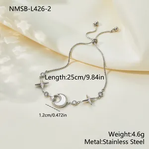 Detailed view of an adjustable stainless steel bracelet with moon and star charms