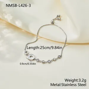 Detailed view of an adjustable stainless steel bracelet with shell and zircon accents.