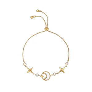 Detail of gold-plated stainless steel bracelet with mother of pearl moon and zircon stars.