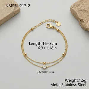 Macro view of double-layer stainless steel bracelet with beads and clear stone detail