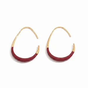 Elegant gold-rimmed C-shaped hoop earrings with burgundy enamel for a retro vintage look.