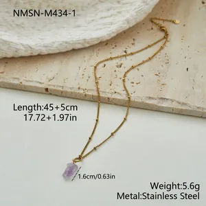 Detailed view of purple amethyst pendant on a gold stainless steel beaded chain necklace.