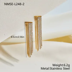 Macro view of gold stainless steel tassel earrings with rhinestone details and size info