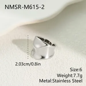 Macro detail of irregular wavy texture on silver stainless steel wide ring
