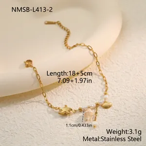 Detail of gold stainless steel bracelet with shell and pearl charms and size dimensions