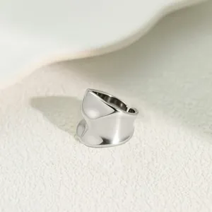 Detailed macro view of an irregular wavy texture stainless steel wide open ring