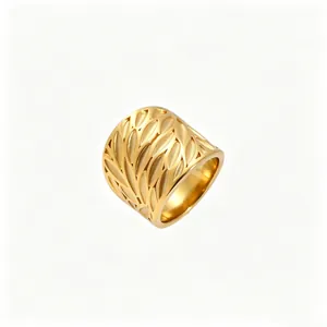 Detail showing the intricate hollowed-out leaf pattern on a wide gold stainless steel ring.