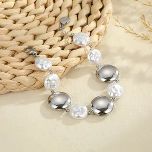 Detailed view of the baroque pearls and polished stainless steel discs on this bracelet.