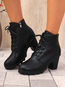 Detailed side view of women's black chunky heel lace-up ankle boots with side zipper