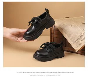 Detailed view of black British style leather shoes for boys with thick soles and laces