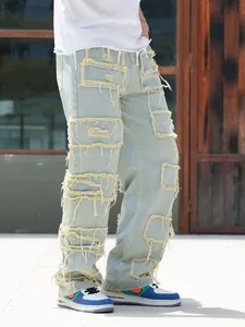 Detailansicht der lockeren Herren-Jeans mit mehreren Fransen-Patches im Distressed-Look.