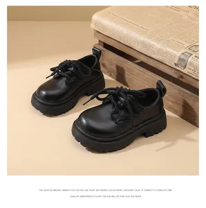 Detailed view of boys' black English style leather shoes on a vintage background