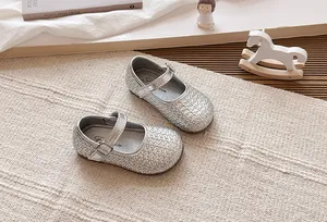 Primer plano de la textura trenzada plateada de los zapatos Mary Jane para niñas