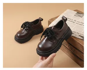 Close-up detail of dark brown British style boy's leather shoes with thick soles.