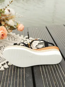 Detailed view of bohemian wedge sandals with white non-slip platform sole