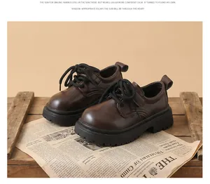 Dark brown British style boys leather shoes displayed on a vintage newspaper and wood crate