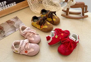 Close-up of children's German training shoes in multiple colors with floral details.