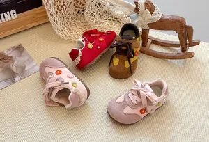 Macro view of girls' stylish trainers featuring floral embroidery and delicate lace trim