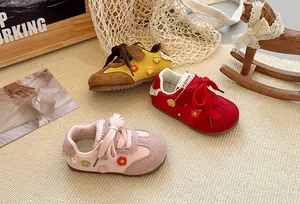 Detail of children's German trainer style sneakers with colorful floral embroidery detail