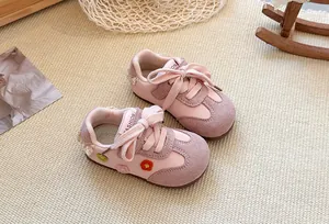 Close-up of pink girls' German trainer sneakers with floral embroidery details