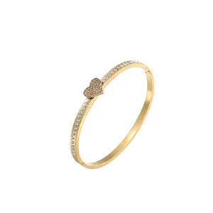 Detailed view of elegant gold stainless steel heart bangle with sparkling rhinestones