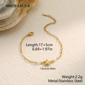 Detailed macro view of a gold stainless steel bracelet with starfish charm and pearls