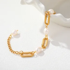 Detailed macro view of an elegant gold-plated stainless steel chain bracelet with white pearls