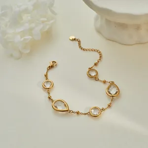 Macro view of light luxury gold bracelet with sparkling clear zirconia stones.