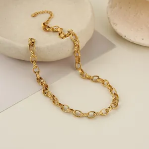 Macro view of gold stainless steel link chain with intricate embossed diamond pattern