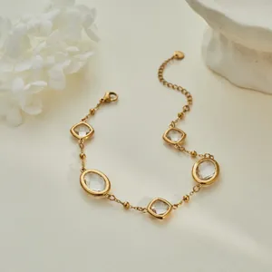 Macro view of gold-plated chain bracelet featuring clear oval and rhombus zircons