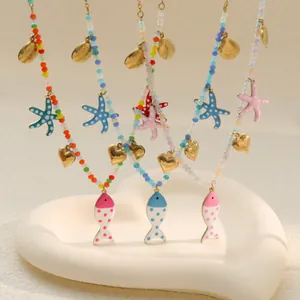Detail view of colorful beaded necklaces with enamel fish and starfish pendants.